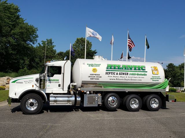 Atlantic Sitton Services truck displays multiple flags in parking lot